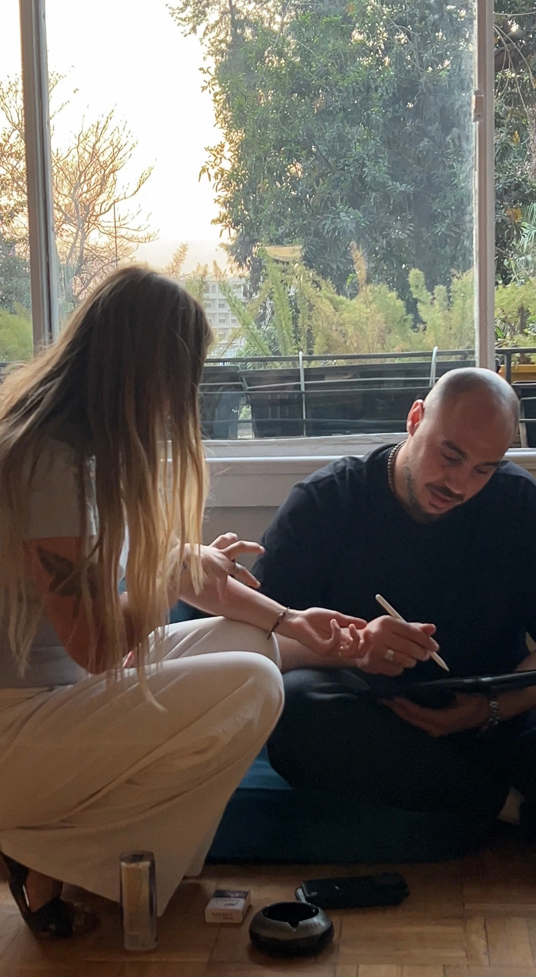 Artist and client in a consultation discussion at MORSE INK